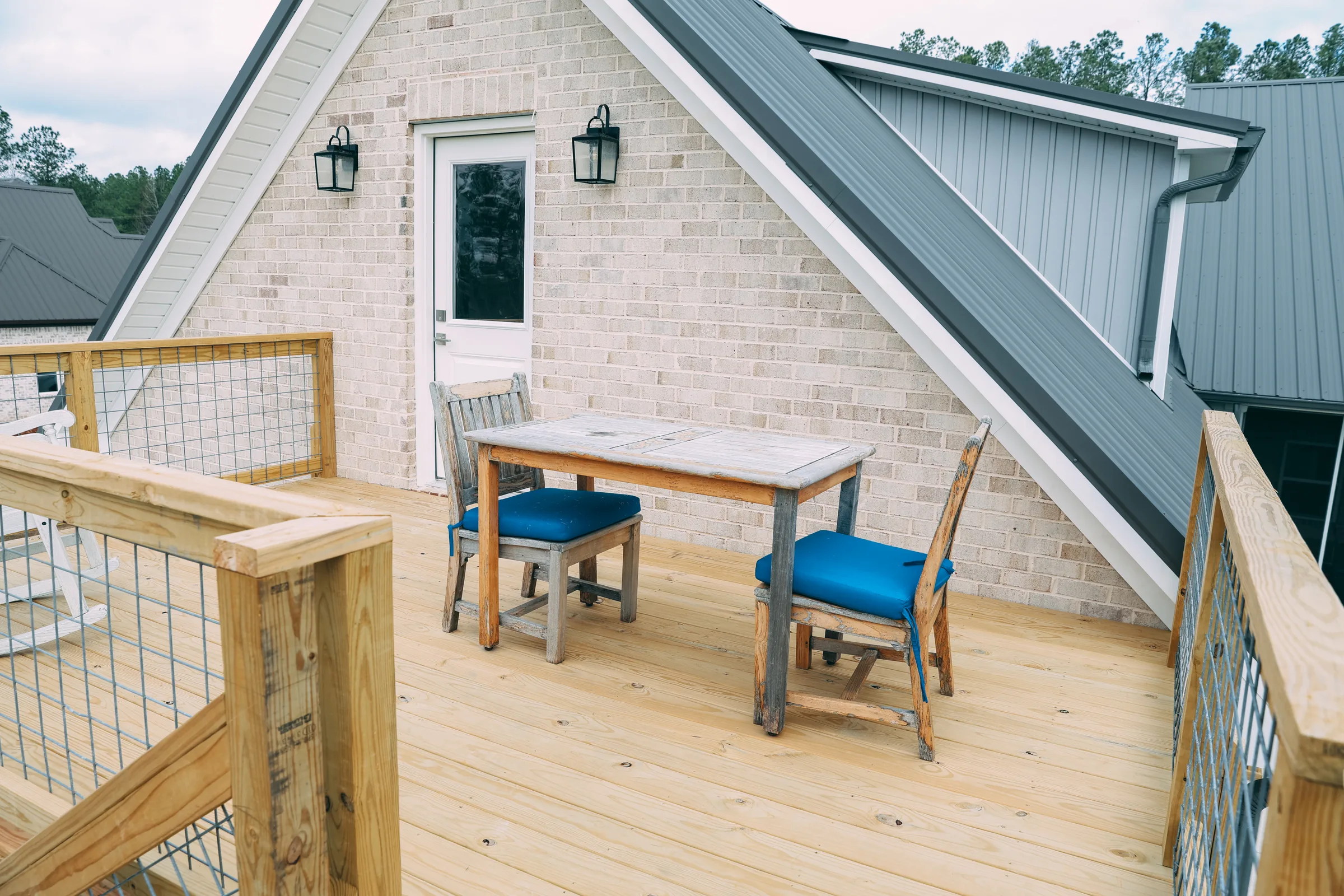 Outdoor living space with decking and railing by Waterstone