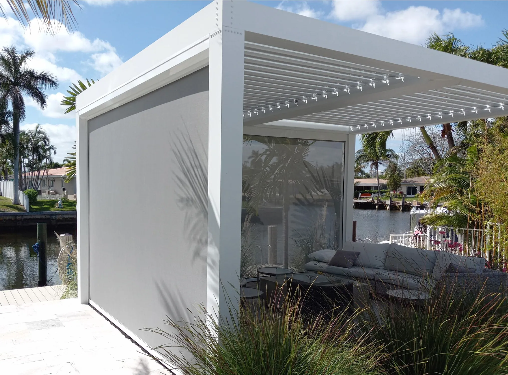 Pergola with MaestroShield retractable exterior screens shading an outdoor seating area